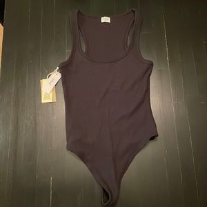 New with tags, black ribbed body suit from Aritzia Wilfred Free in size xs